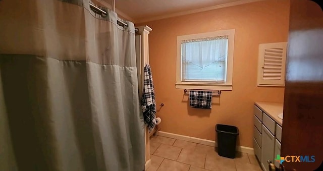 bathroom with ornamental molding, vanity, and tile patterned floors