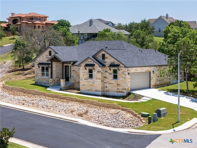 101 Dawna Len Dr, Burnet, TX 78611 - view of front of house featuring stone siding, concrete driveway, a garage, and a front yard