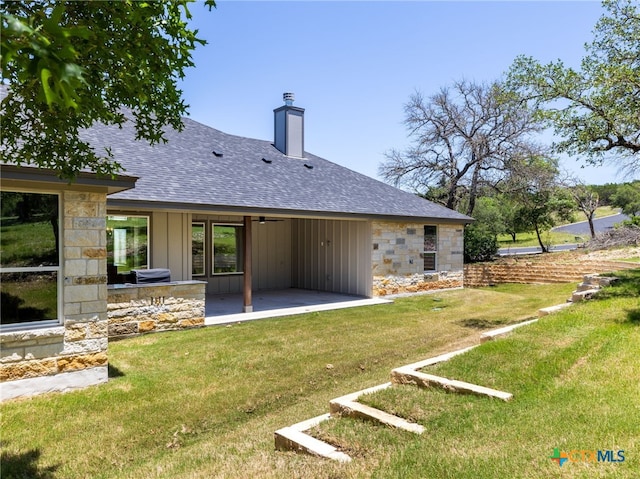 101 Dawna Len Dr, Burnet, TX 78611 - back of house with a shingled roof, a patio area, stone siding, and a chimney