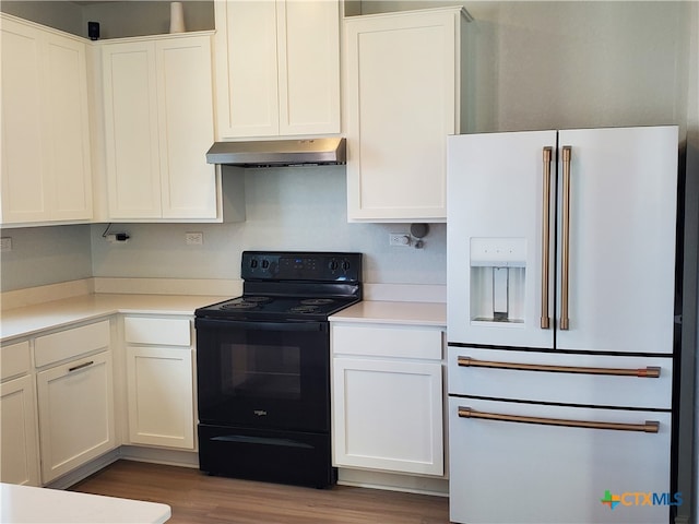 kitchen with wood-type flooring, white cabinetry, black range with electric stovetop, and high end white refrigerator