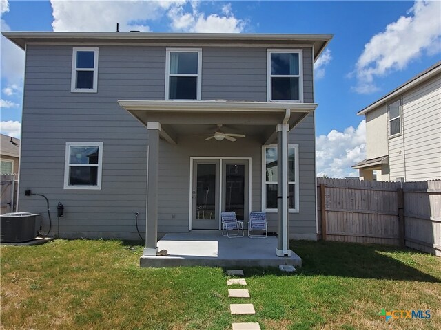 back of property featuring central AC unit, a patio, a lawn, and ceiling fan