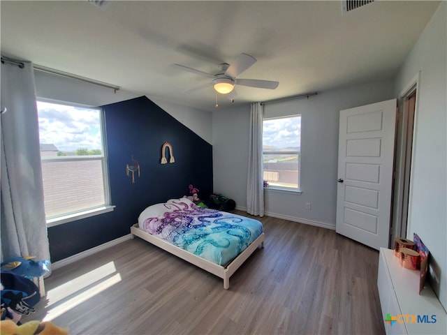 bedroom with wood-type flooring and ceiling fan