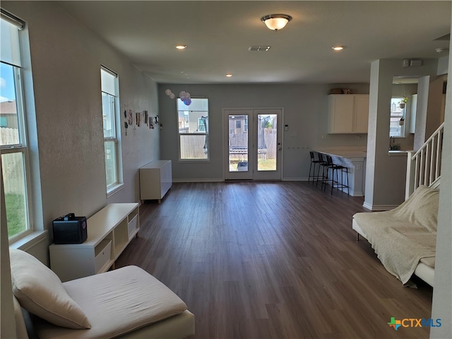 living room with a wealth of natural light and dark hardwood / wood-style floors