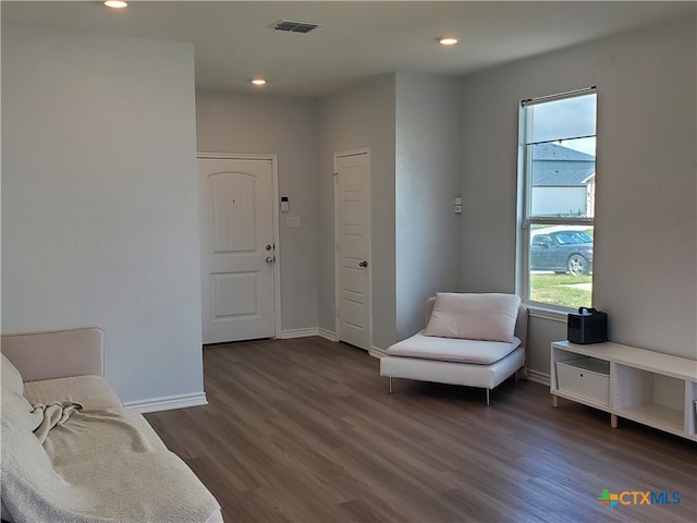 sitting room featuring dark wood-type flooring