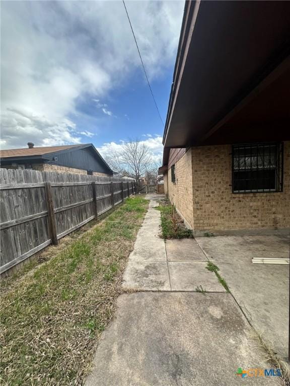 view of yard featuring a patio and fence