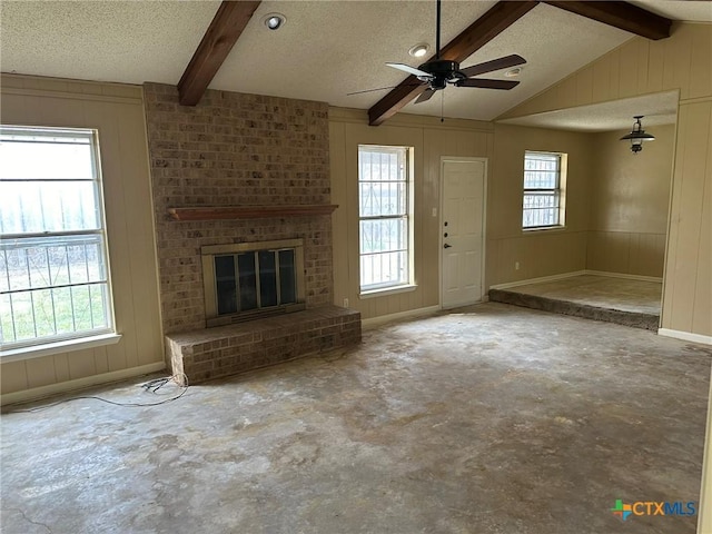 unfurnished living room with a healthy amount of sunlight, concrete floors, and a textured ceiling