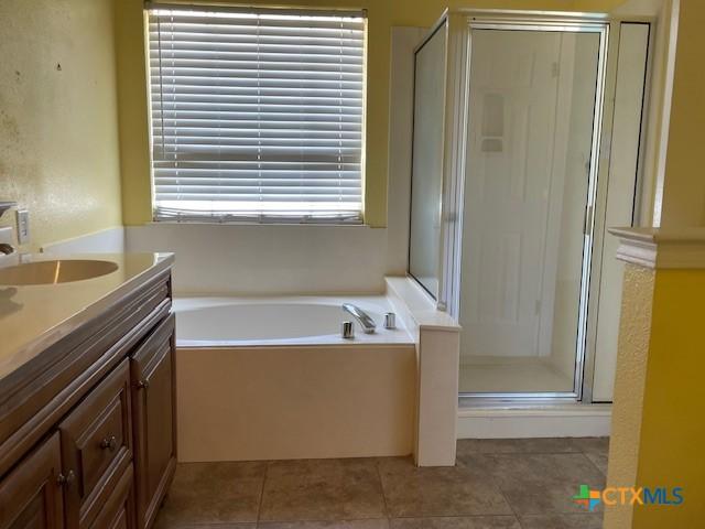 517 Crazy Horse Cir, Harker Heights, TX 76548 - bathroom featuring a stall shower, a bath, vanity, and tile patterned flooring