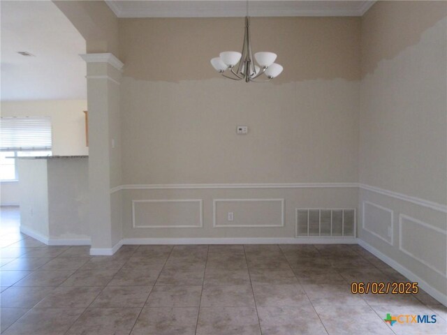 517 Crazy Horse Cir, Harker Heights, TX 76548 - unfurnished dining area with a chandelier, tile patterned flooring, a decorative wall, wainscoting, and ornate columns