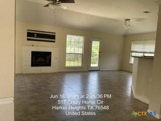 517 Crazy Horse Cir, Harker Heights, TX 76548 - unfurnished living room with a ceiling fan and a fireplace