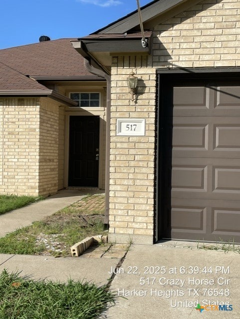 517 Crazy Horse Cir, Harker Heights, TX 76548 - property entrance featuring brick siding and roof with shingles