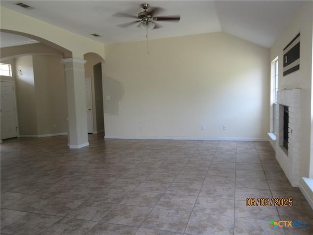 517 Crazy Horse Cir, Harker Heights, TX 76548 - unfurnished living room featuring arched walkways, ceiling fan, a brick fireplace, lofted ceiling, and decorative columns
