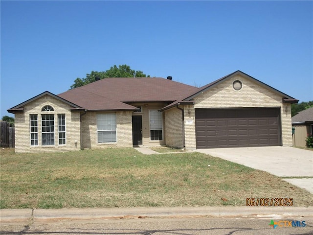 517 Crazy Horse Cir, Harker Heights, TX 76548 - single story home featuring an attached garage, brick siding, concrete driveway, and a front lawn