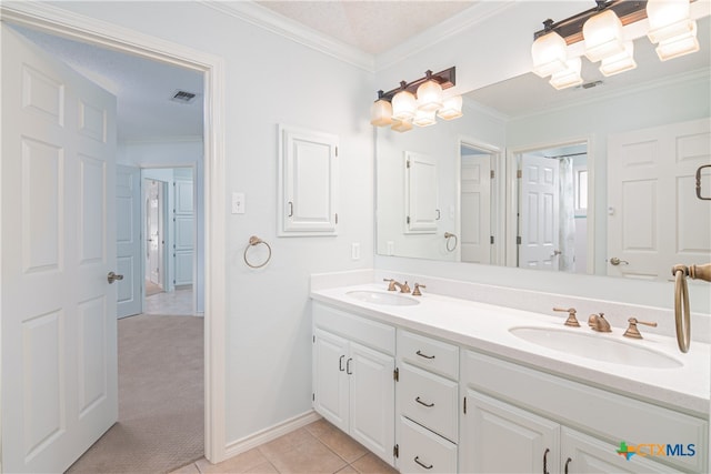 bathroom with vanity, tile patterned floors, a textured ceiling, and ornamental molding