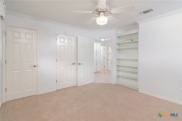 unfurnished bedroom with ornamental molding, light carpet, and ceiling fan