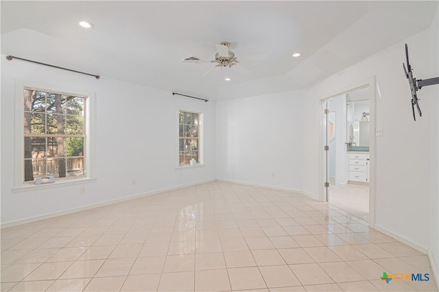 tiled empty room with ceiling fan