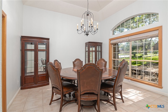 tiled dining area featuring a notable chandelier