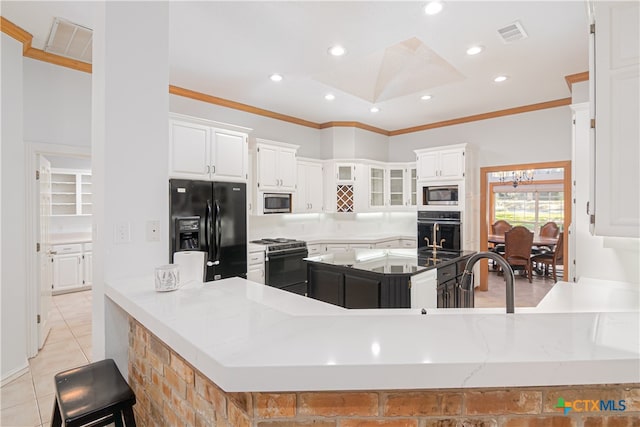 kitchen featuring kitchen peninsula, white cabinets, light tile patterned floors, and stainless steel appliances