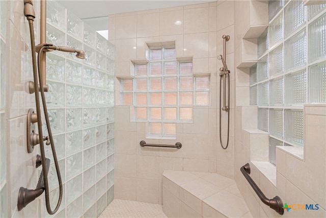 bathroom with a tile shower