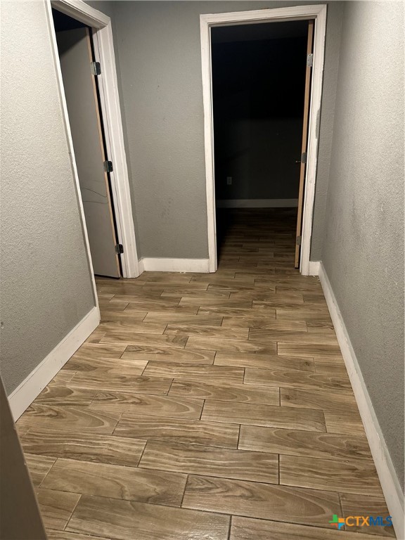 corridor with light hardwood / wood-style flooring