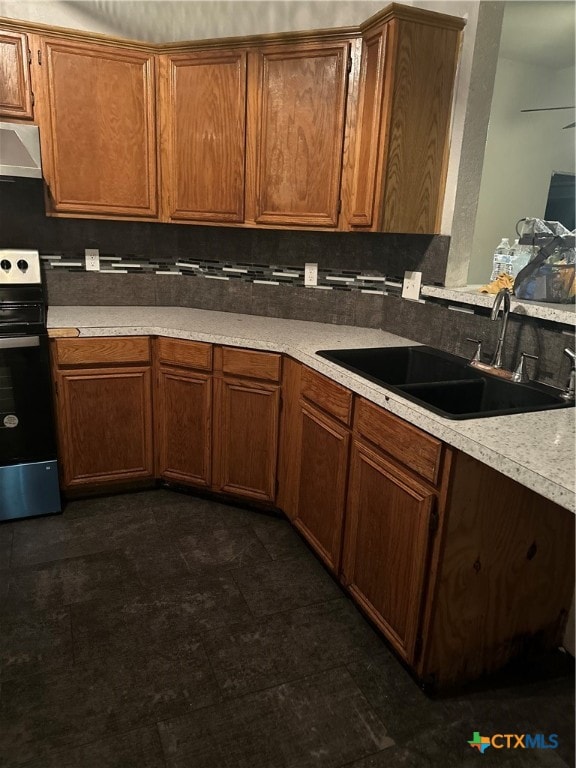 kitchen featuring range with electric cooktop, sink, and range hood