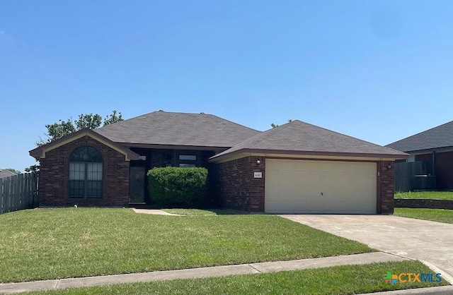 4110 Windwood Dr, Killeen, TX 76542 - single story home with brick siding, a garage, central AC unit, and driveway