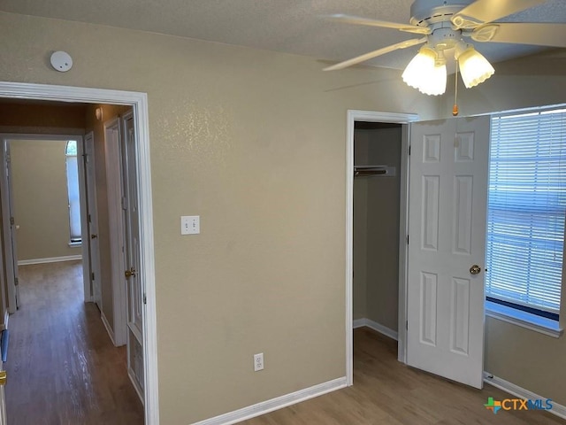 4110 Windwood Dr, Killeen, TX 76542 - unfurnished bedroom with wood finished floors, baseboards, a closet, and a ceiling fan