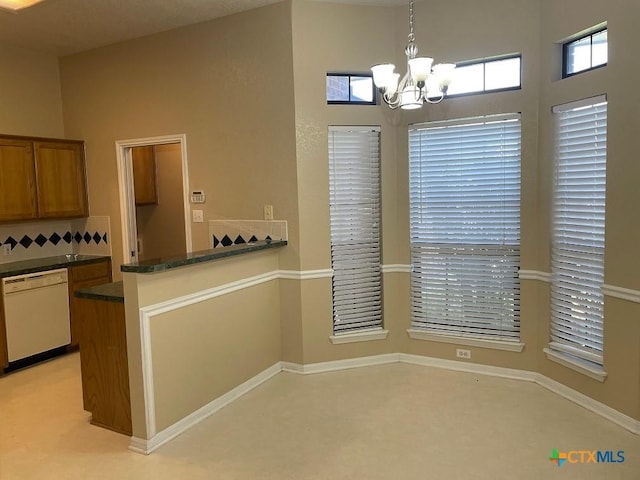 4110 Windwood Dr, Killeen, TX 76542 - kitchen featuring white dishwasher, a chandelier, brown cabinetry, decorative light fixtures, and a peninsula