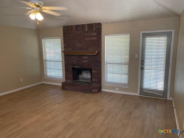 4110 Windwood Dr, Killeen, TX 76542 - unfurnished living room featuring wood finished floors, baseboards, ceiling fan, and a brick fireplace