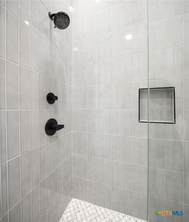 bathroom with tiled shower