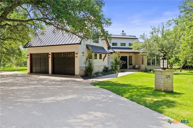 view of front of house with a garage and a front yard