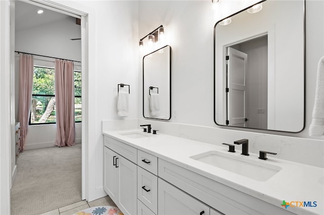 bathroom featuring lofted ceiling, vanity, and tile patterned floors