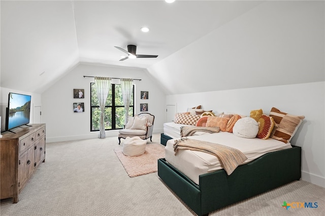 bedroom with ceiling fan, lofted ceiling, and light colored carpet