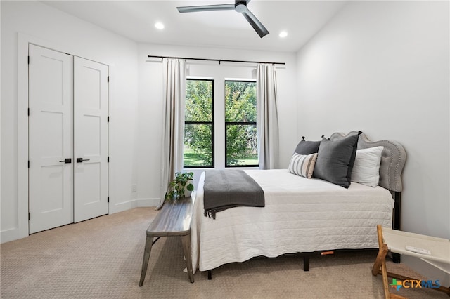 bedroom with ceiling fan and light carpet