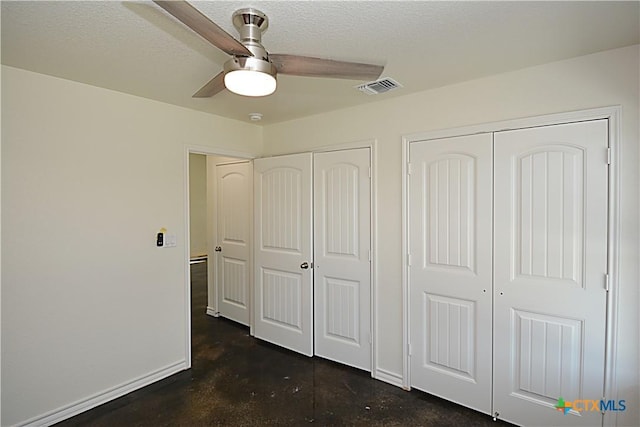 521 Lariat Pass, Spring Branch, TX 78070 - unfurnished bedroom featuring two closets, concrete flooring, and a ceiling fan