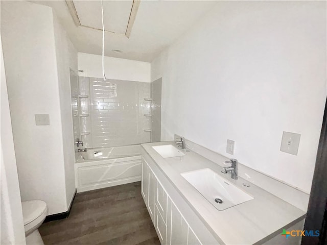 full bathroom featuring toilet, tiled shower / bath combo, sink, and hardwood / wood-style flooring