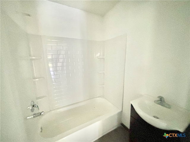 bathroom featuring vanity and tiled shower / bath