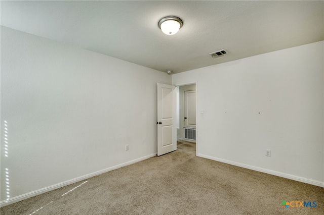 unfurnished bedroom featuring visible vents, baseboards, and light colored carpet