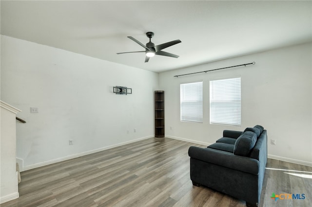 sitting room featuring baseboards, ceiling fan, and wood finished floors