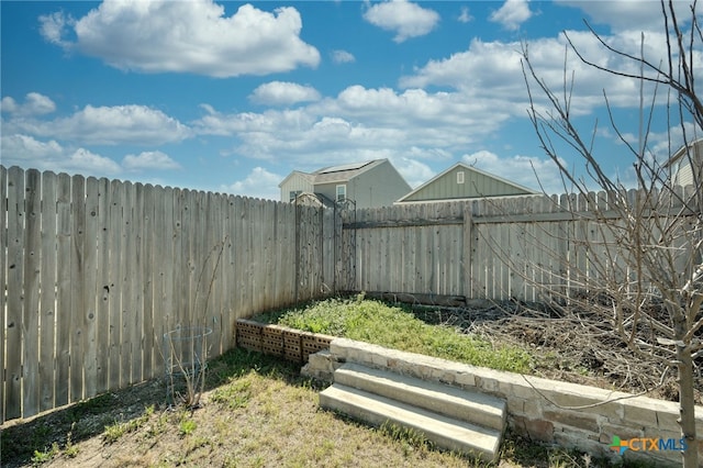 view of yard with a fenced backyard