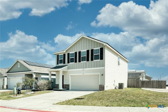 view of front of property featuring board and batten siding, fence, concrete driveway, a front yard, and a garage