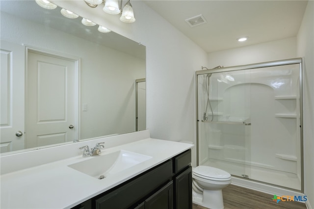 full bath with visible vents, vanity, toilet, and a shower stall