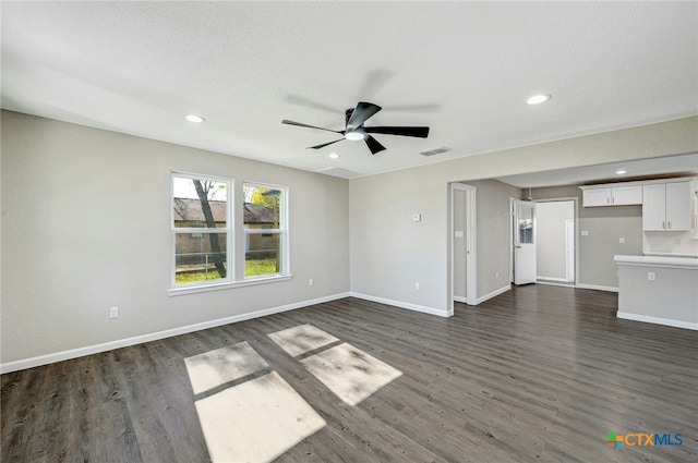 212 S Walnut Ave, Luling, TX 78648 - unfurnished living room featuring dark wood-style flooring, ceiling fan, and recessed lighting