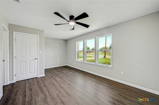 212 S Walnut Ave, Luling, TX 78648 - unfurnished bedroom featuring dark wood finished floors and ceiling fan