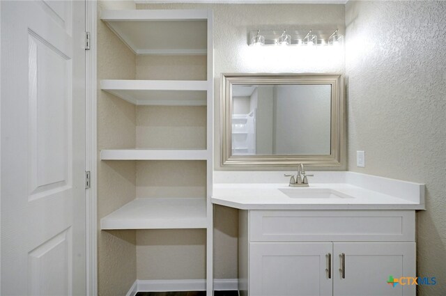 212 S Walnut Ave, Luling, TX 78648 - bathroom featuring vanity and a textured wall