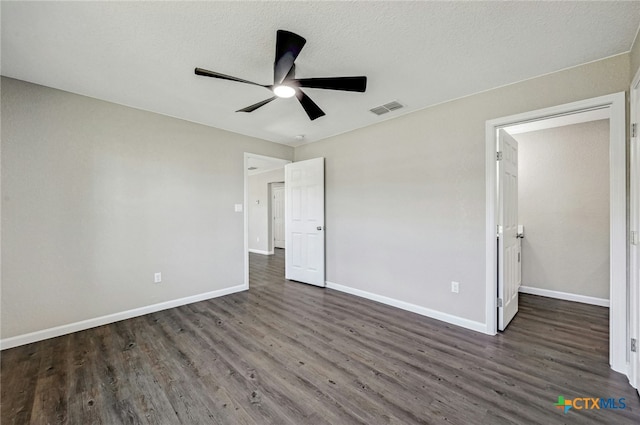 unfurnished bedroom with ceiling fan, dark wood-type flooring, and a textured ceiling