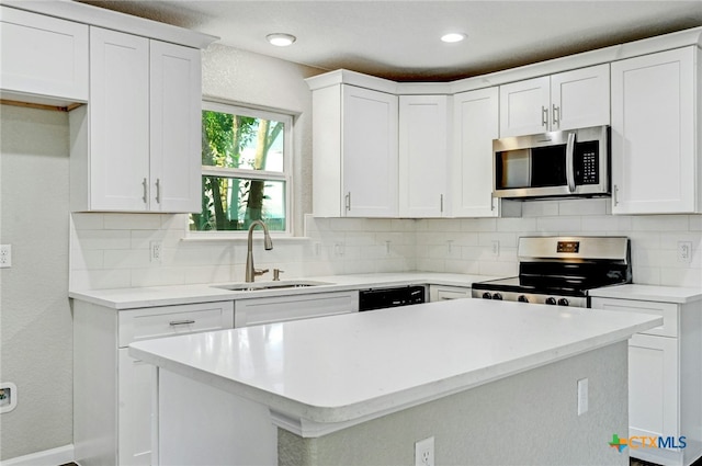 212 S Walnut Ave, Luling, TX 78648 - kitchen featuring stainless steel appliances, light countertops, decorative backsplash, white cabinets, and recessed lighting