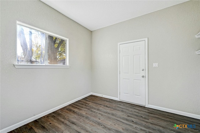 212 S Walnut Ave, Luling, TX 78648 - spare room with baseboards and dark wood-type flooring