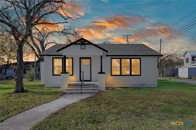 bungalow-style home with a lawn