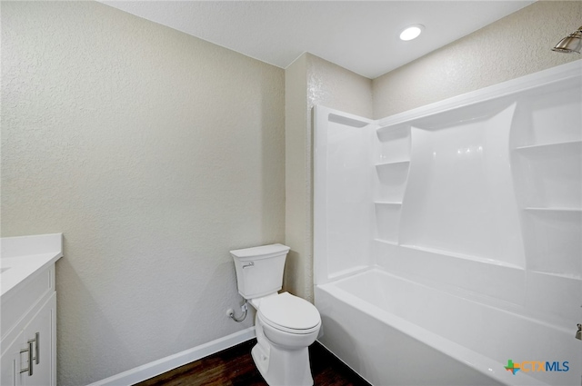 212 S Walnut Ave, Luling, TX 78648 - full bathroom with wood finished floors, vanity, a textured wall, and bathtub / shower combination