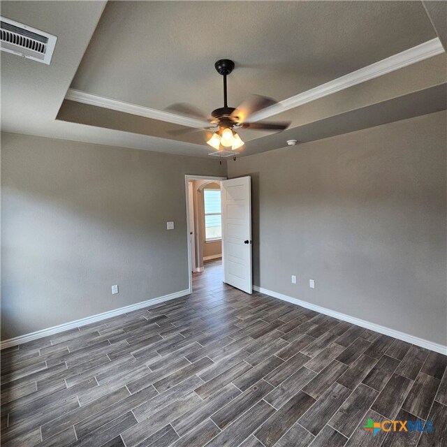 spare room featuring ornamental molding, dark hardwood / wood-style floors, and ceiling fan